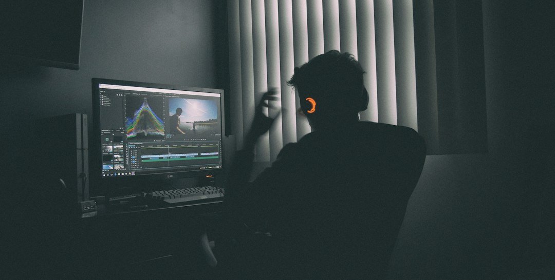 Professional video editor working at a computer