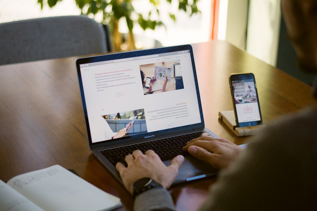 Professional discussing a website project on a laptop